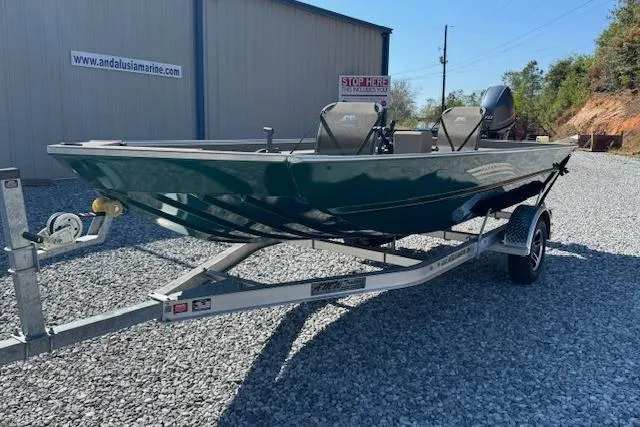Slide: The Image of 2025 Alweld 1856 PF boat on trailer, parked on gravel near a building. - 4