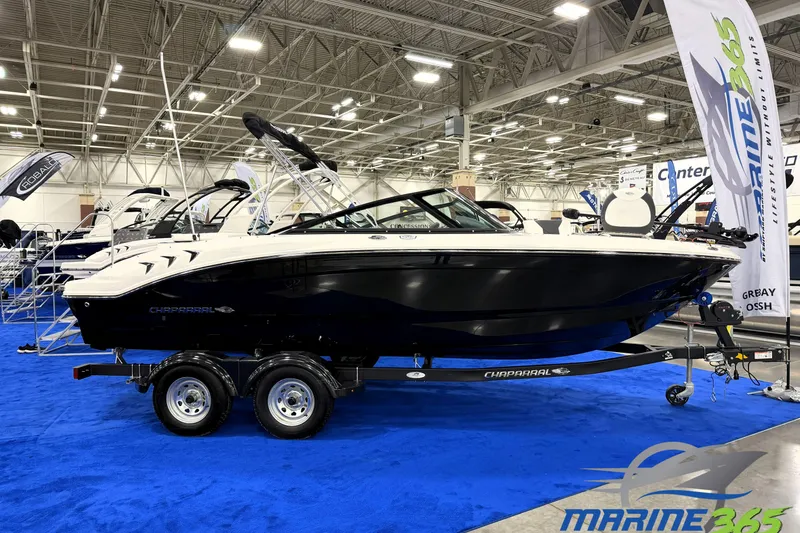 The Image of 2026 Chaparral 21 SSi Ski & Fish boat displayed indoors on a trailer. - 0