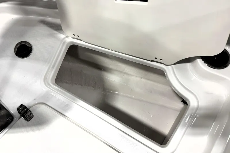 Slide: The Image of 2026 Chaparral 21 SSi Ski & Fish boat storage compartment, white interior detail. - 13