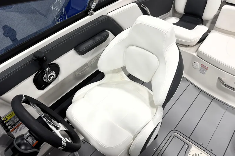Slide: The Image of 2026 Chaparral 21 SSi Ski & Fish boat interior with white seating and steering wheel. - 20