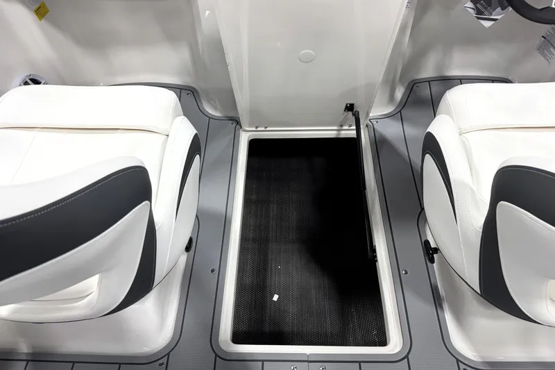 Slide: The Image of Interior of 2026 Chaparral 21 SSi Ski & Fish boat with white seating and storage compartment. - 29
