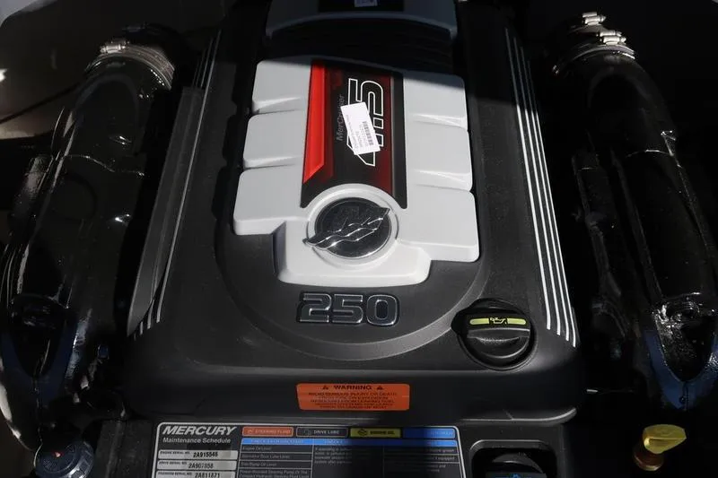 Slide: The Image of 2026 Chaparral 21 SSi boat with sleek design, docked near a building. - 13