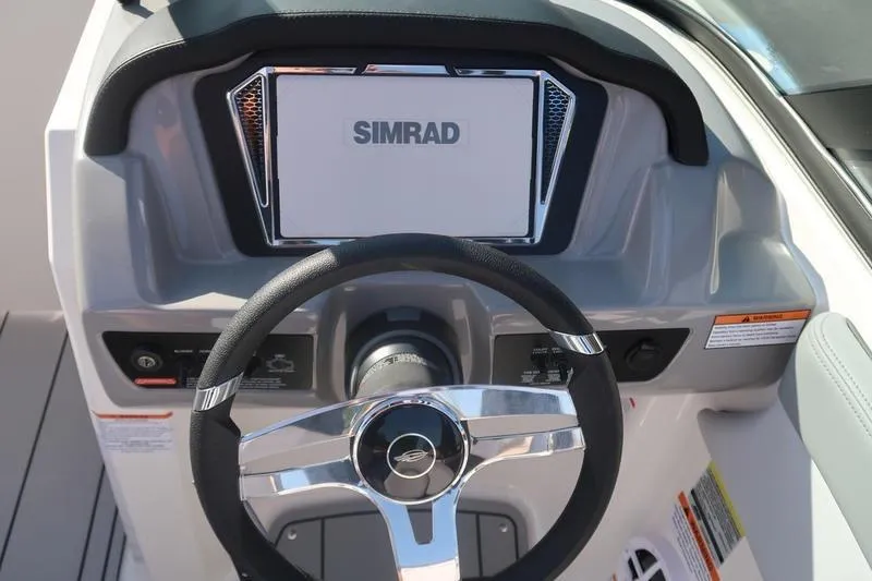 Slide: The Image of Storage compartment of 2026 Chaparral 21 SSi boat with black mat lining. - 15