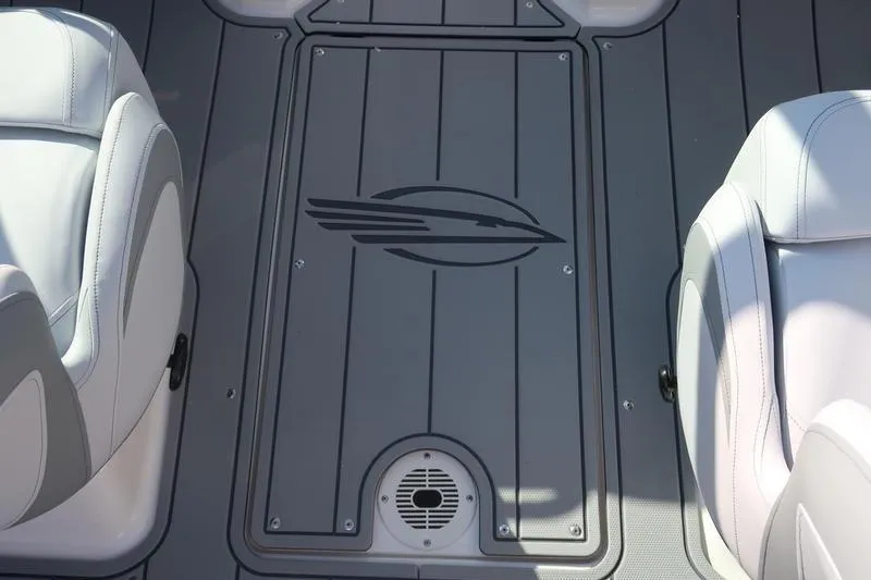 Slide: The Image of 2026 Chaparral 21 SSi boat dashboard with storage compartment and cup holder. - 17