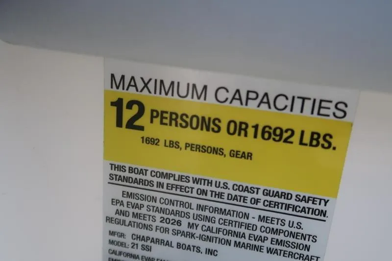 Slide: The Image of 2026 Chaparral 21 SSi boat compartment with red switch, white interior. - 19
