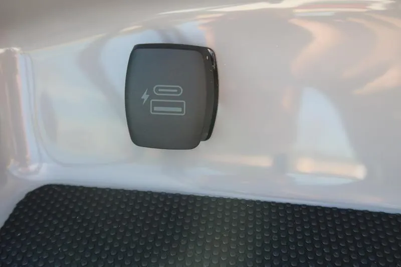 Slide: The Image of Interior view of 2026 Chaparral 21 SSi boat with modern seating and steering wheel. - 21