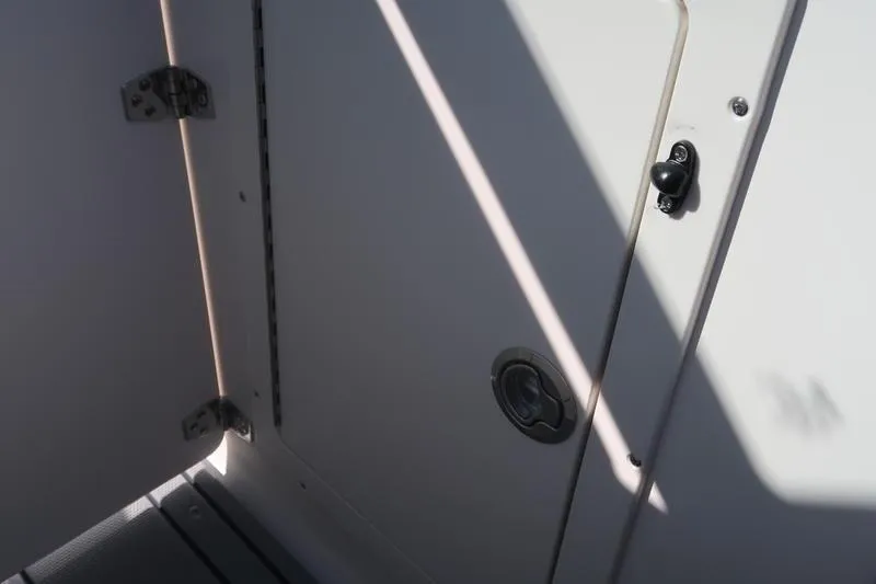 Slide: The Image of Interior storage compartment of 2026 Chaparral 21 SSi boat, featuring sleek design and durable materials. - 22
