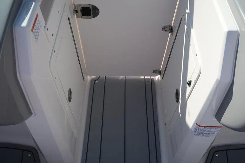 Slide: The Image of Storage compartment of 2026 Chaparral 21 SSi boat with black non-slip mat. - 23