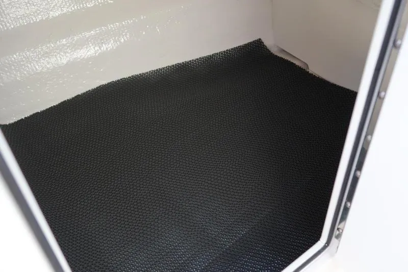 Slide: The Image of Interior view of 2026 Chaparral 21 SSi boat with textured flooring and blue seat. - 24