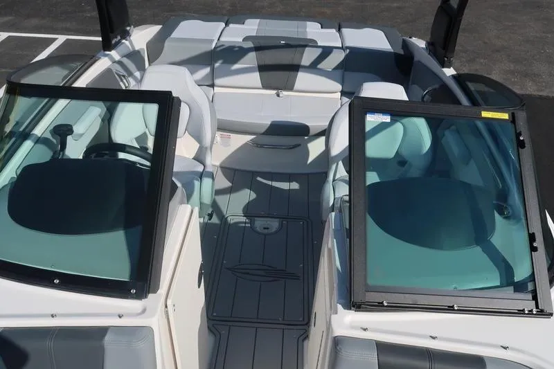Slide: The Image of 2026 Chaparral 21 SSi boat interior with seating and windshield, viewed from above. - 29