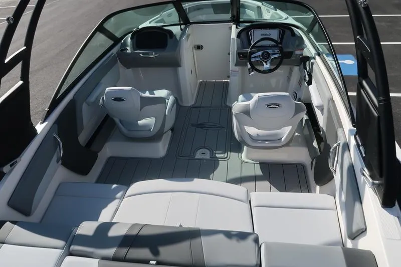 Slide: The Image of 2026 Chaparral 21 SSi boat on trailer in parking lot, sunny day. - 7