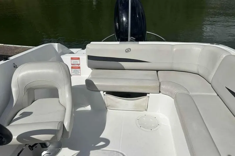 Slide: The Image of 2023 Hurricane SunDeck Sport 188 IO boat interior with white seating and helm chair. - 4