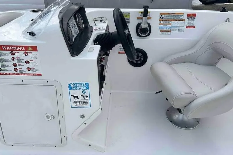Slide: The Image of 2023 Hurricane SunDeck Sport 188 IO boat cockpit with steering wheel and captain's chair. - 6