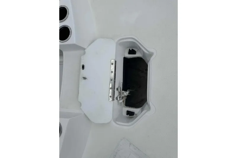Slide: The Image of 2023 Hurricane SunDeck Sport 188 IO boat storage compartment with open hatch and rope. - 7
