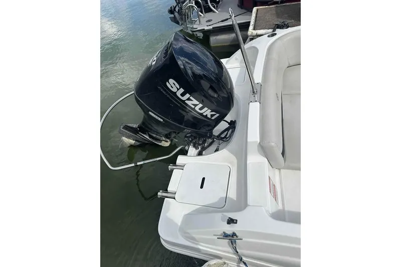 Slide: The Image of 2023 Hurricane SunDeck Sport 188 IO with Suzuki outboard motor on calm water. - 9