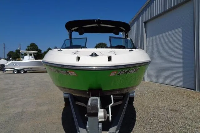 Slide: The Image of 2018 Chaparral Vortex 243 VRX boat in green, parked on a trailer. - 10