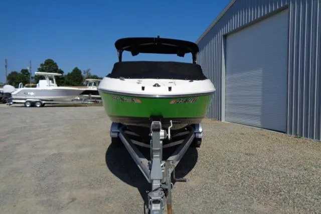 Slide: The Image of 2018 Chaparral Vortex 243 VRX boat on trailer, green hull, parked outdoors. - 4
