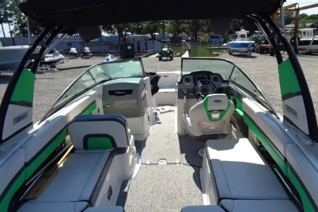Slide: The Image of 2018 Chaparral Vortex 243 VRX boat interior with green accents and modern dashboard. - 8