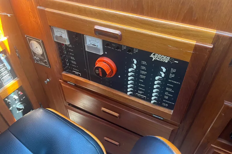 Slide: The Image of Control panel of a 1990 Cooper Prowler 35 yacht with switches and gauges. - 17