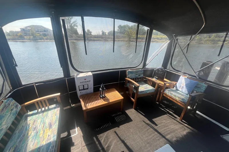 Slide: The Image of Interior of 1990 Cooper Prowler 35 boat with seating and river view. - 3