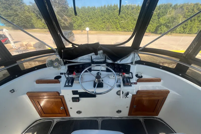 Slide: The Image of Cockpit of 1990 Cooper Prowler 35 boat with steering wheel and control panel. - 5