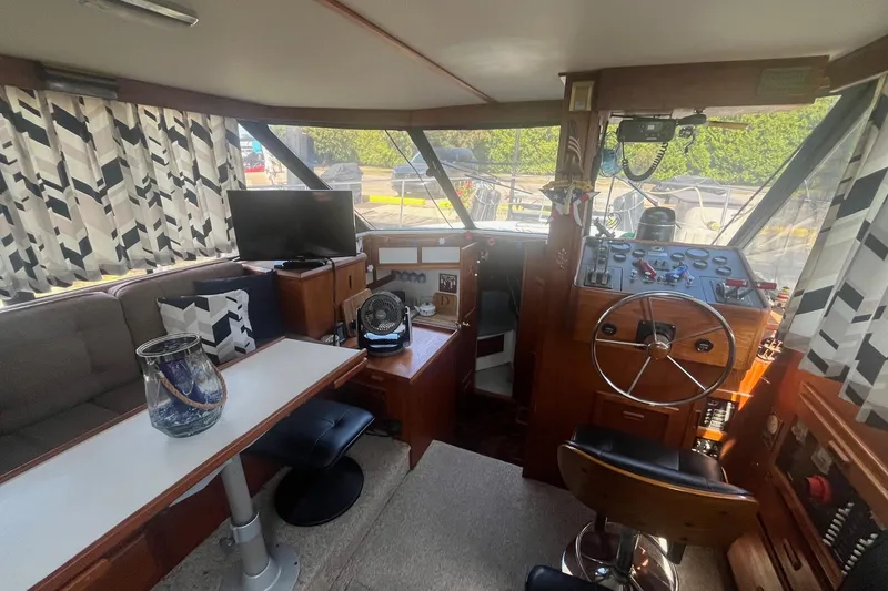 Slide: The Image of Interior of 1990 Cooper Prowler 35 boat with helm, seating, and decor. - 7