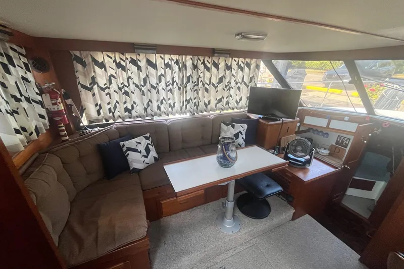 Slide: The Image of Cozy interior of 1990 Cooper Prowler 35 boat with seating, table, and decor. - 8
