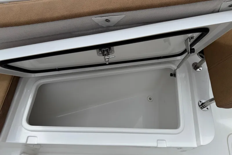 Slide: The Image of 2021 Sea Hunt Gamefish 27 Forward Seating storage compartment, open with brown seating. - 13