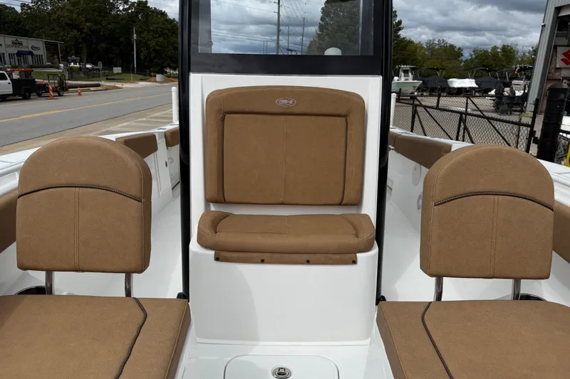 Slide: The Image of 2021 Sea Hunt Gamefish 27 Forward Seating with tan upholstery, parked outdoors. - 15