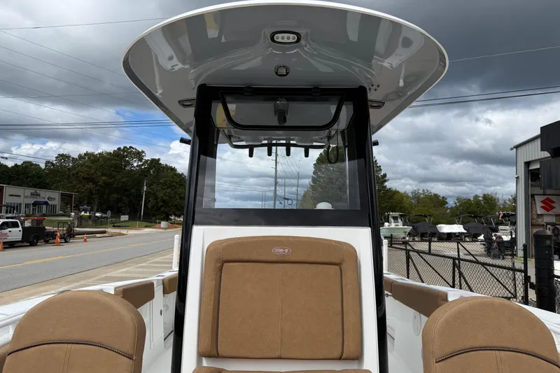 Slide: The Image of 2021 Sea Hunt Gamefish 27 boat with forward seating, docked under cloudy skies. - 18