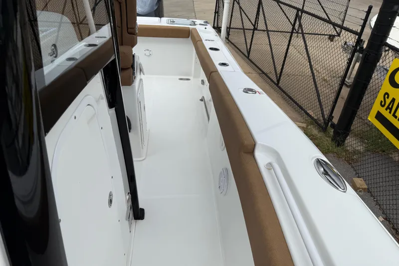 Slide: The Image of 2021 Sea Hunt Gamefish 27 boat interior with forward seating, white and brown accents. - 22