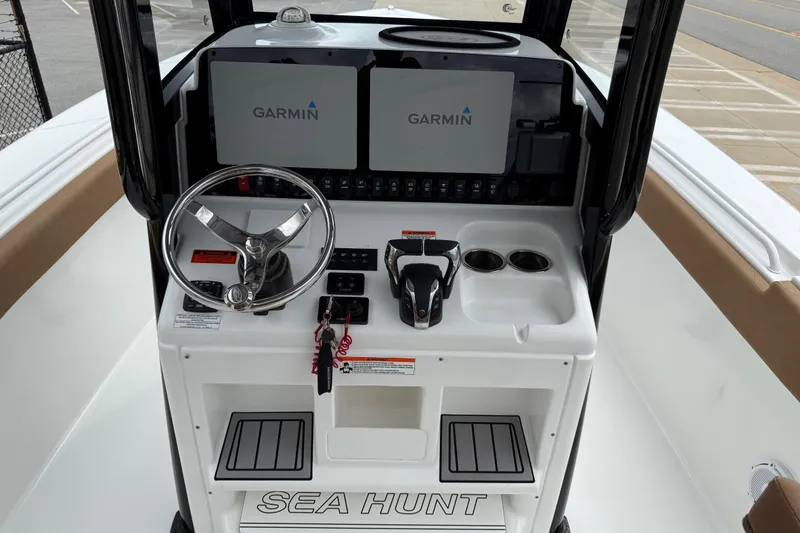 Slide: The Image of 2021 Sea Hunt Gamefish 27 helm with dual Garmin displays and steering wheel. - 23