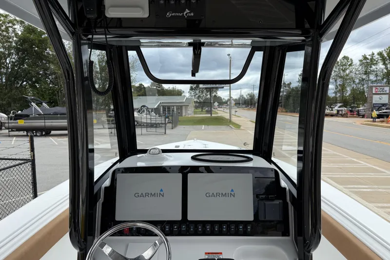 Slide: The Image of 2021 Sea Hunt Gamefish 27 boat dashboard with Garmin navigation displays. - 24