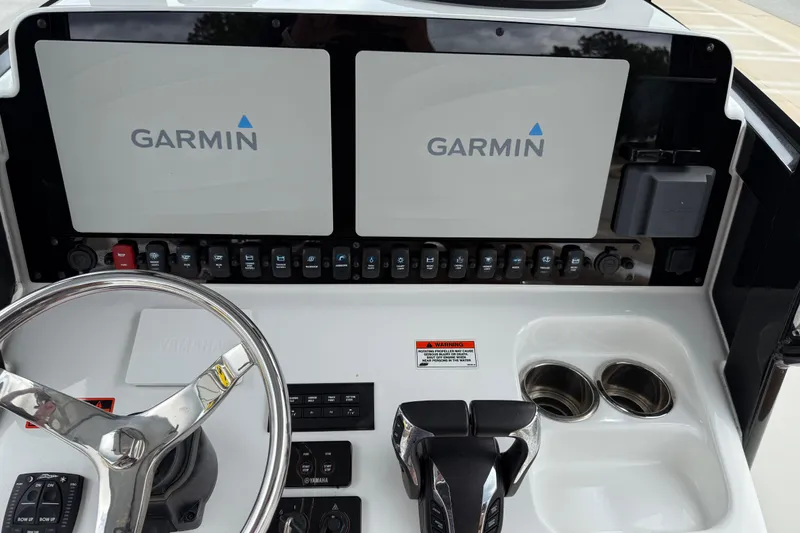 Slide: The Image of 2021 Sea Hunt Gamefish 27 helm with dual Garmin displays and Yamaha controls. - 30