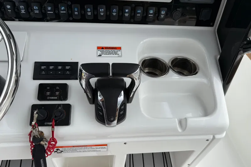 Slide: The Image of 2021 Sea Hunt Gamefish 27 console with controls and cup holders. - 33