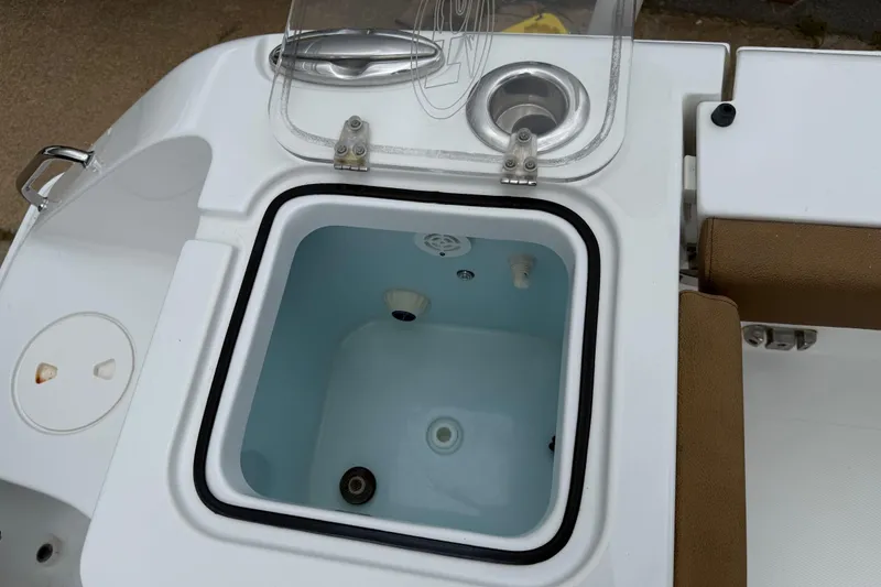 Slide: The Image of Livewell on 2021 Sea Hunt Gamefish 27 Forward Seating boat, featuring open lid and cup holder. - 39