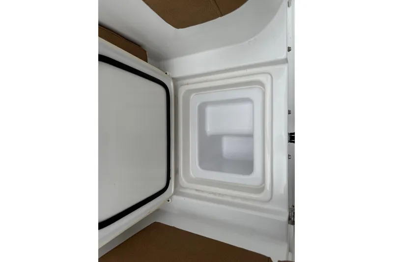 Slide: The Image of 2021 Sea Hunt Gamefish 27 Forward Seating storage compartment, open and empty. - 44