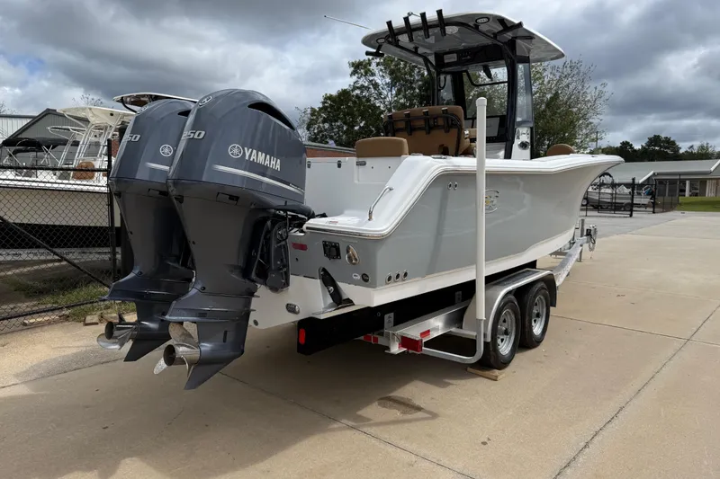 Slide: The Image of 2021 Sea Hunt Gamefish 27 boat with dual Yamaha engines on a trailer. - 5