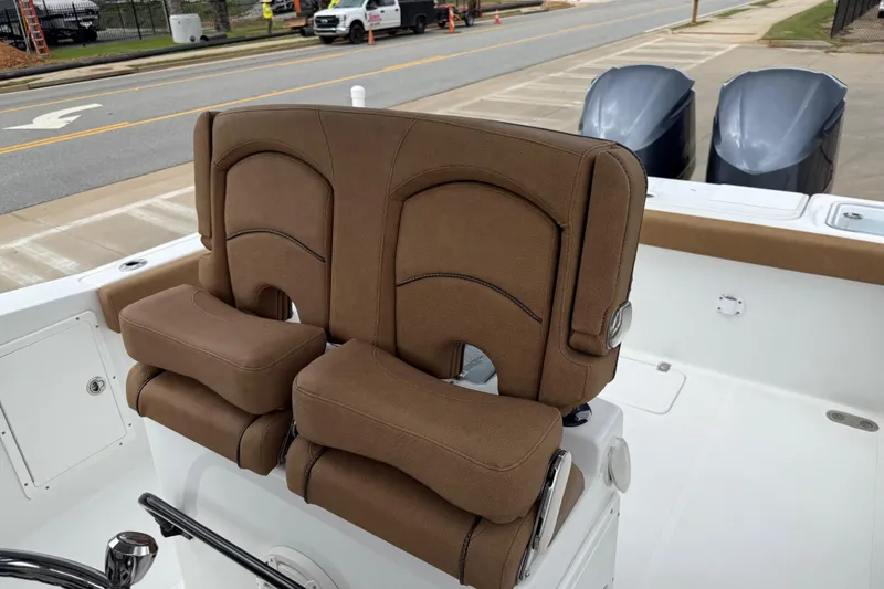 Slide: The Image of 2021 Sea Hunt Gamefish 27 boat with brown forward seating and dual engines. - 56