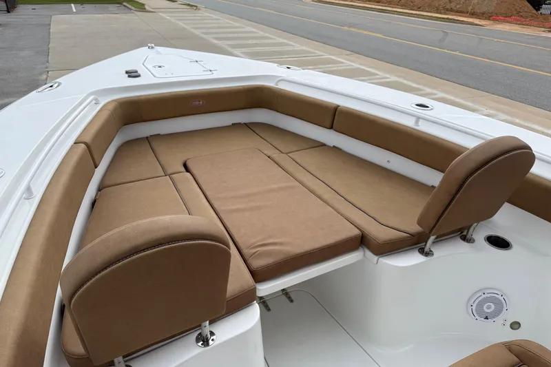 Slide: The Image of 2021 Sea Hunt Gamefish 27 Forward Seating with tan cushions, docked on pavement. - 59