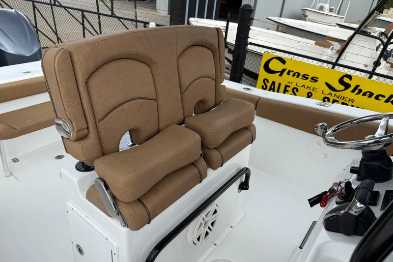 Slide: The Image of 2021 Sea Hunt Gamefish 27 boat with tan forward seating and steering wheel. - 61