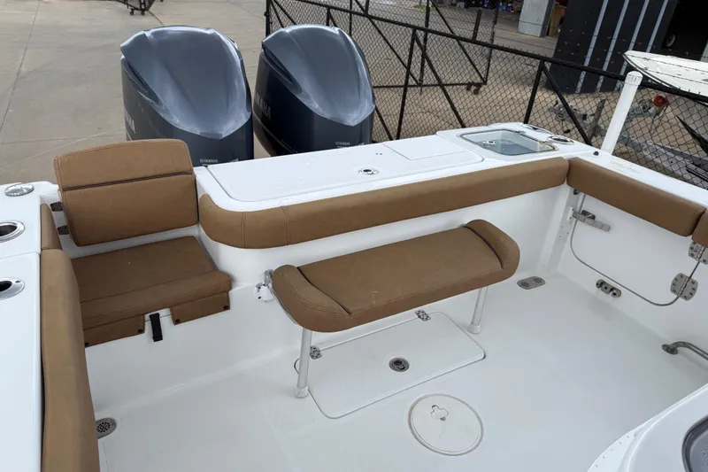 Slide: The Image of 2021 Sea Hunt Gamefish 27 boat interior with seating and dual Yamaha engines. - 64