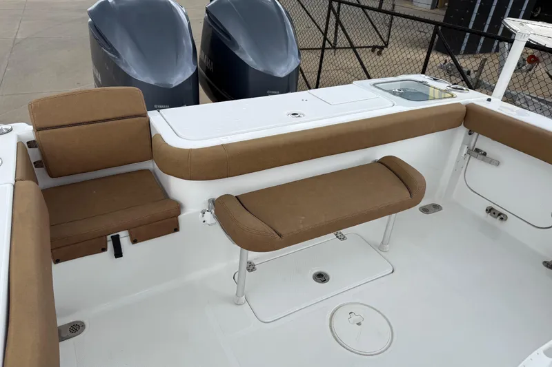 Slide: The Image of 2021 Sea Hunt Gamefish 27 boat interior with brown seating and dual Yamaha engines. - 65