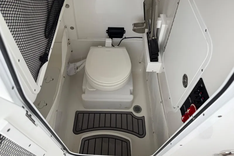 Slide: The Image of 2021 Sea Hunt Gamefish 27 boat interior with toilet and storage features. - 66
