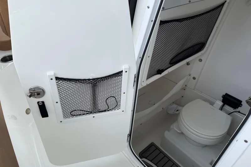 Slide: The Image of 2021 Sea Hunt Gamefish 27 boat interior with toilet and storage compartments. - 67