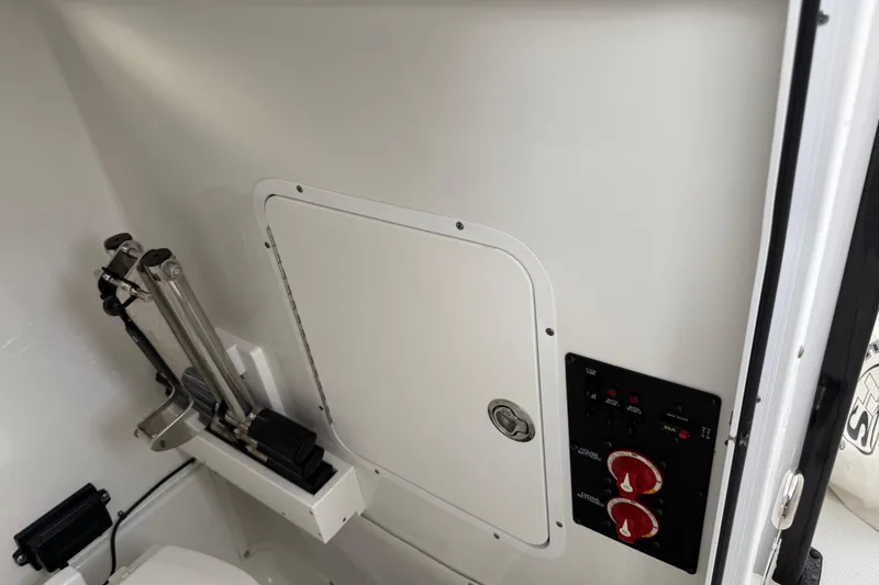 Slide: The Image of 2021 Sea Hunt Gamefish 27 interior with control panel and storage compartment. - 68