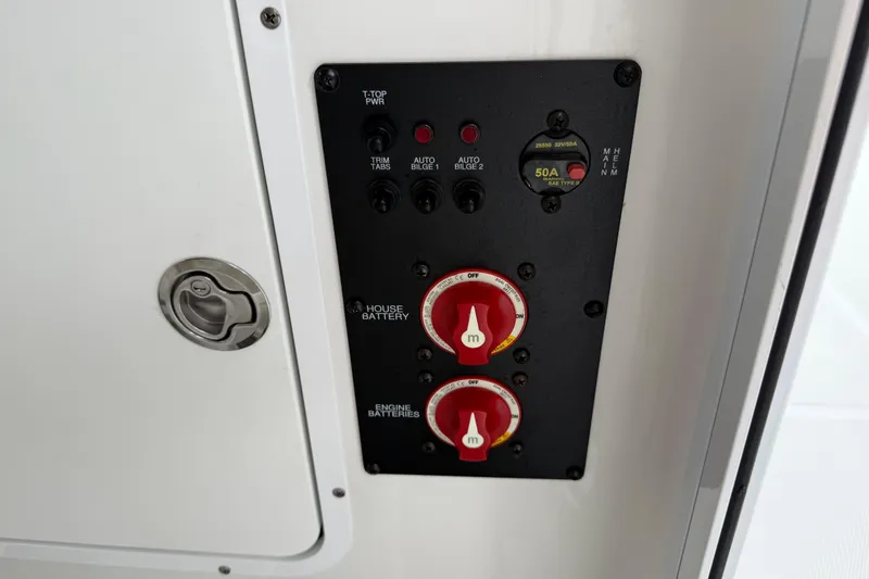 Slide: The Image of Control panel on 2021 Sea Hunt Gamefish 27 boat, featuring battery switches and circuit breakers. - 69