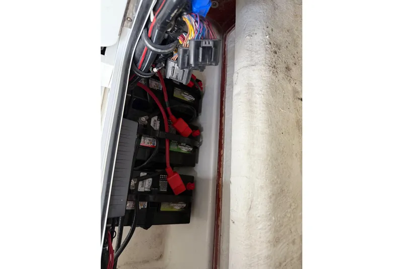 Slide: The Image of 2021 Sea Hunt Gamefish 27 boat battery compartment with wiring and connections. - 71