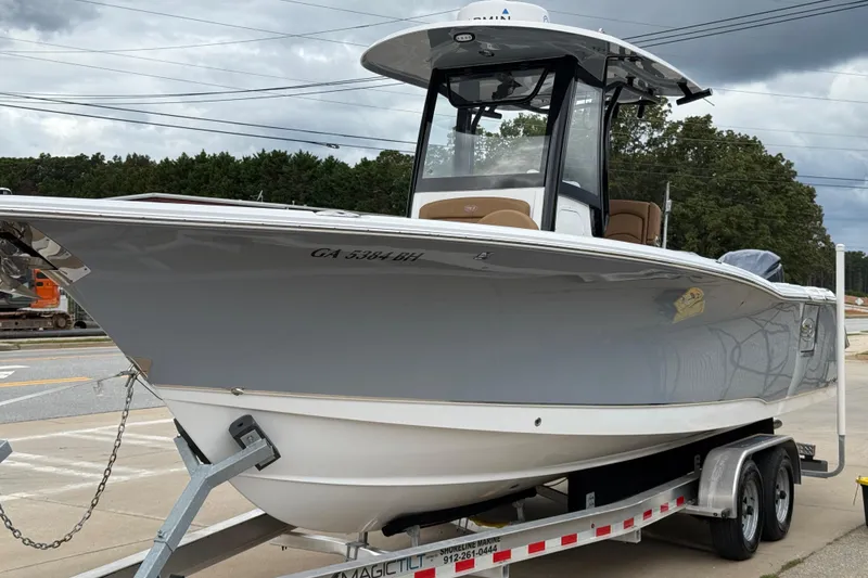 Slide: The Image of 2021 Sea Hunt Gamefish 27 Forward Seating boat on trailer, parked outdoors. - 74