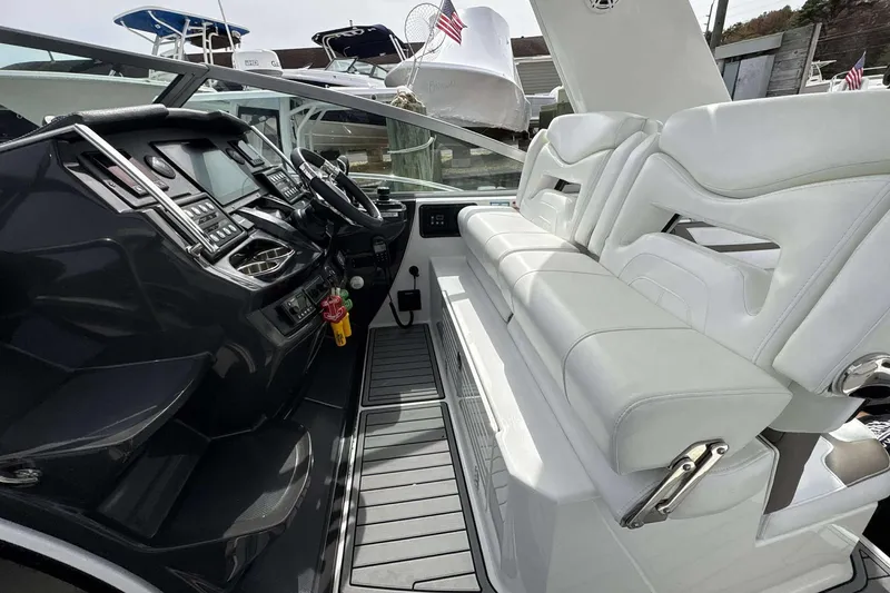 Slide: The Image of 2020 Monterey 355 Sport Yacht cockpit with sleek dashboard and white seating. - 10